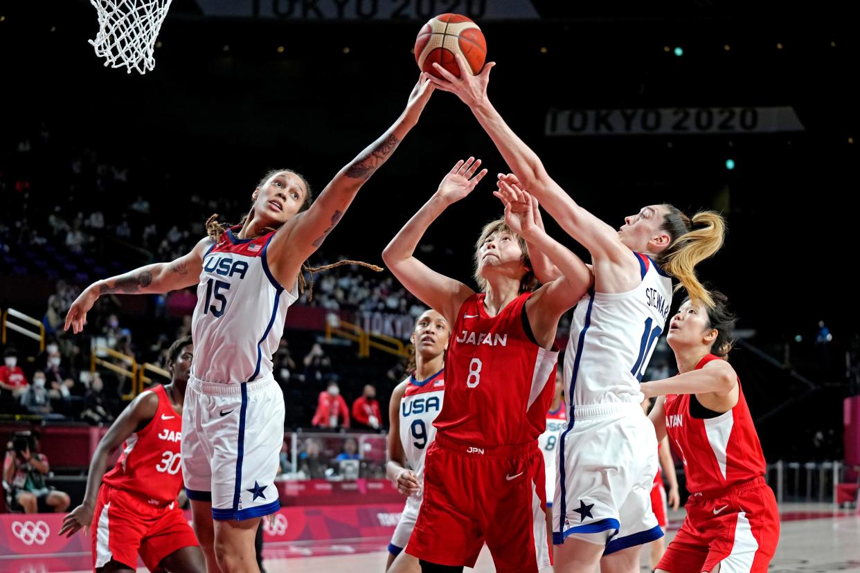 Team USA center Brittney Griner (15) and forward Breanna Stewart (10) battle for a rebound with Japan center Maki Takada (8) during the gold-medal match at the Tokyo Olympics.