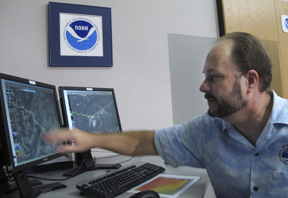 Tom Evans, acting director of the Central Pacific Hurricane Center, shows satellite images of Hurricane Flossie in Honolulu on Monday, July 29, 2013. A tropical storm making its way toward Hawaii had residents of Maui and the Big Island on Monday bracing for possible flooding, 60 mph wind gusts and waves that could reach as high as 18 feet. Tropical Storm Flossie could also bring mudslides, tornadoes and waterspouts, forecasters said. (AP Photo/Oskar Garcia)