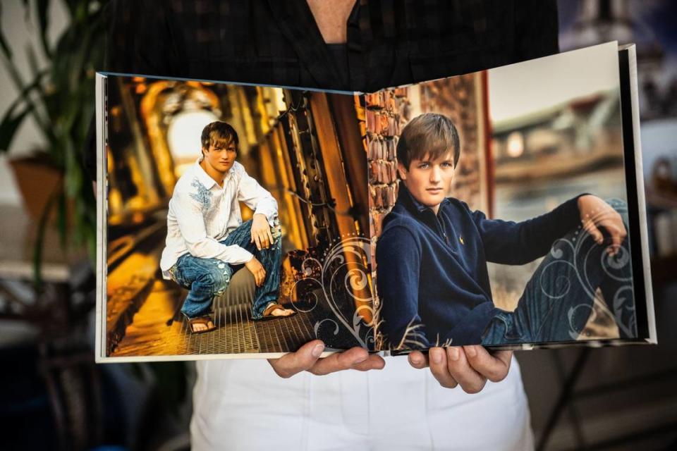 Deanna Hampton of Auburn holds a book with photos of her late son Trevor, who was abused by Father Michael Kelly while serving as an altar boy at the Catholic church in San Andreas.