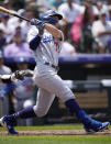Los Angeles Dodgers' James Outman follows the flight of his two-run home run off Colorado Rockies starting pitcher German Marquez in the third inning of a baseball game, Sunday, July 31, 2022, in Denver. (AP Photo/David Zalubowski)