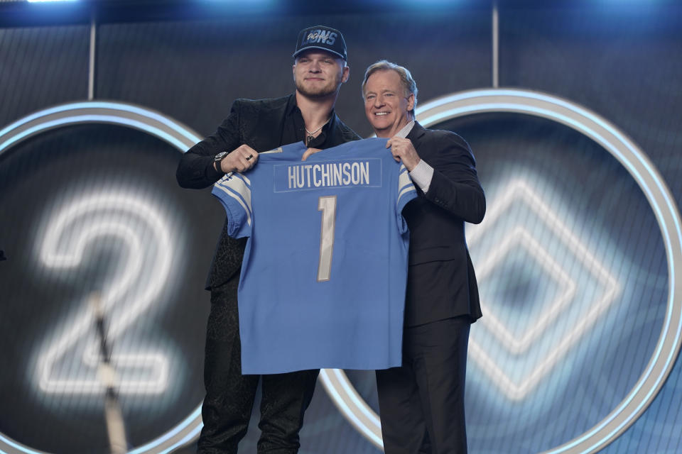 Michigan defensive end Aidan Hutchinson stands next to NFL Commissioner Roger Goodell after being selected by the Detroit Lions as the second pick in the NFL football draft Thursday, April 28, 2022, in Las Vegas. (AP Photo/Jae C. Hong )