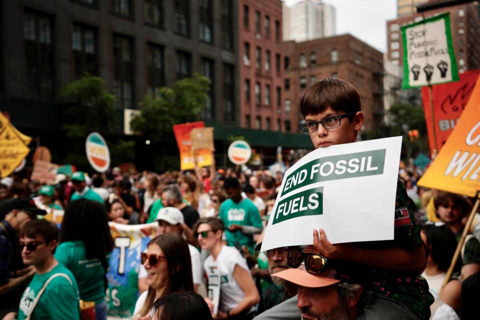 Oliver Moore, 7, of Montpelier, Vermont, listens to a speaker during a rally to end the use of fossil fuels. About 75,000 people took part in Sunday's march in New York.