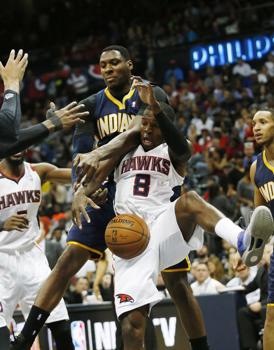 Atlanta Hawks guard Shelvin Mack (8) and Indiana Pacers center Ian Mahinmi battle for a rebound in the first half of Game 3 of an NBA basketball first-round playoff series on Thursday, April 24, 2014, in Atlanta. (AP Photo/John Bazemore)