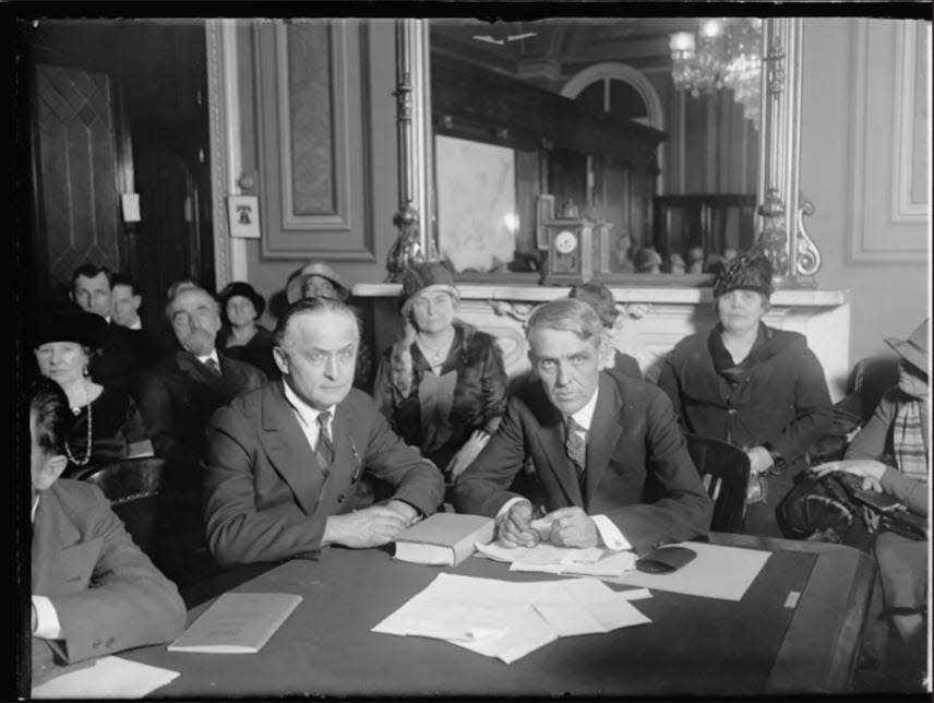 Harry Houdini (seated at center left) with Sen. Arthur Capper (right) at a February 1926 congressional hearing to consider making it illegal to accept money for telling fortunes. Famed escape artist and illusionist Houdini was the star witness at the hearings. A crusader against mediums and psychics, Houdini investigated their practices and showed how they managed their trick.