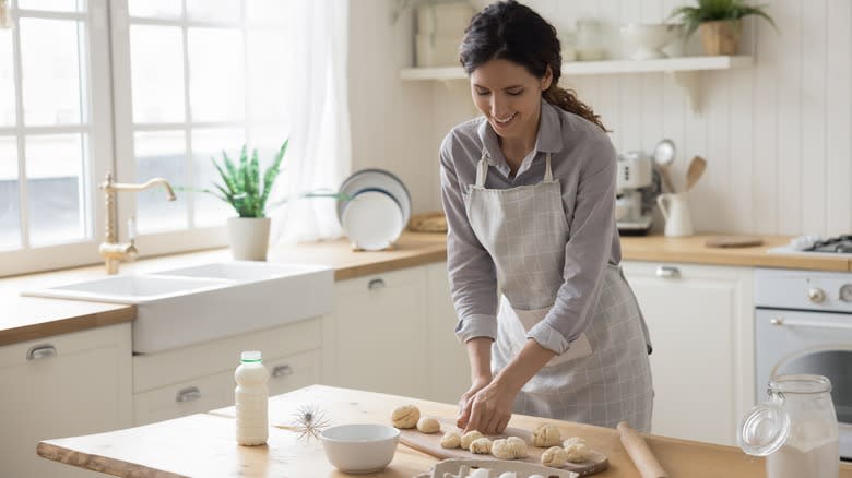 Woman shaping dough balls