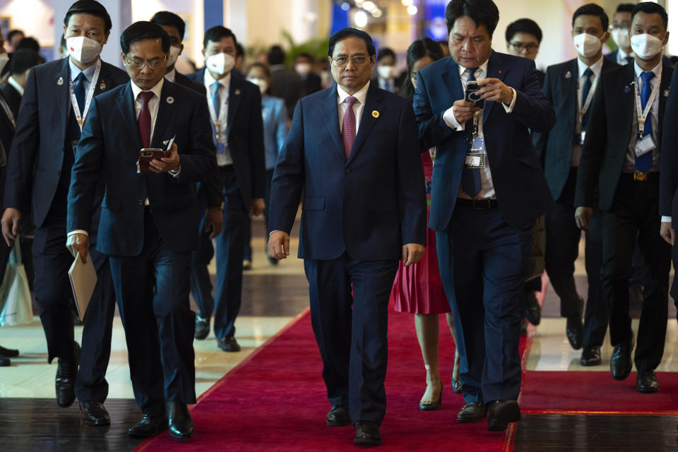 Vietnam's Prime Minister Pham Minh Chinh, middle, arrives for the ASEAN summit in Phnom Penh, Cambodia, Friday, Nov. 11, 2022. The ASEAN summit kicks off a series of three top-level meetings in Asia, with the Group of 20 summit in Bali to follow and then the Asia Pacific Economic Cooperation forum in Bangkok. (AP Photo/Anupam Nath)