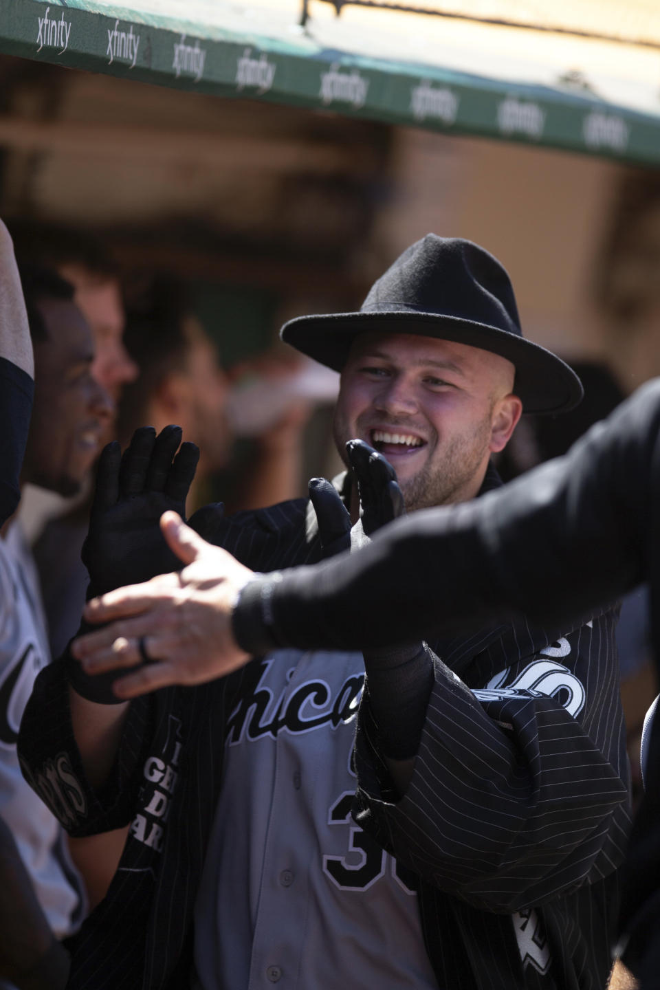 Chicago White Sox's Jake Burger (30) is congratulated by his teammates after hitting a solo home run against the Oakland Athletics during the seventh inning of a baseball game, Sunday, July 2, 2023, in Oakland, Calif. (AP Photo/D. Ross Cameron)