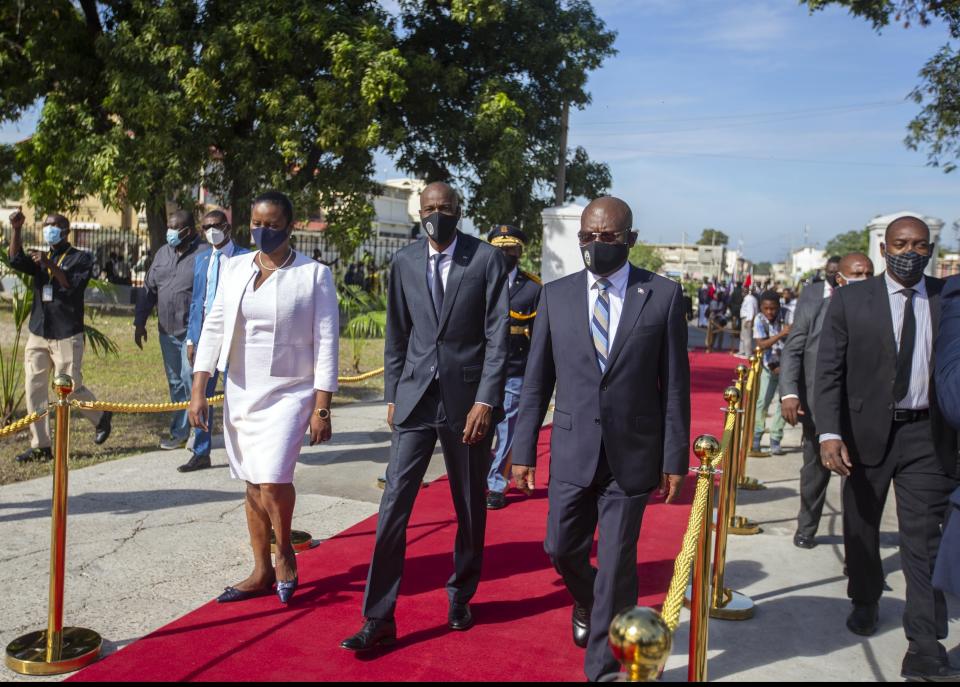 FILE - Haiti's President Jovenel Moise, center, accompanied by his wife Martine, and Prime Minister Joseph Jouthe, center right, arrive to a mausoleum to honor revolutionary leaders Alexandre Petion and Jean Jacques Dessalines during a ceremony commemorating Haiti's final battle before it secured independence from France in 1804, in Port-au-Prince, Haiti, in this Wednesday, Nov. 18, 2020, file photo. Haitian Prime Minister Joseph Jouthe announced early Wednesday, April 14, 2021, that he has resigned as the country faces a spike in killings and kidnappings and prepares for an upcoming constitutional referendum and general election later this year.( AP Photo/Dieu Nalio Chery, File)