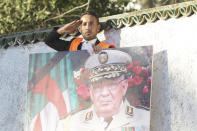 A man gives the military salute during the funeral of late Algerian military chief Gaid Saleh in Algiers, Algeria, Wednesday, Dec. 25, 2019. Algeria is holding an elaborate military funeral for the general who was the de facto ruler of the gas-rich country amid political turmoil throughout this year. (AP Photo/Fateh Guidoum)