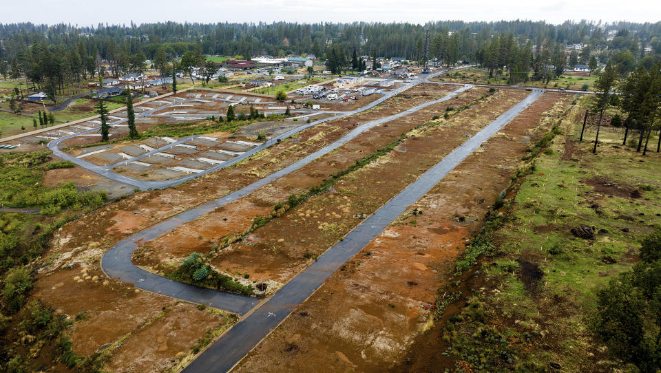 Empty rows line the Ridgewood Mobile Home Park, Wednesday, Oct. 25, 2023, five years after the Camp Fire leveled the Paradise, Calif., retirement community. (AP Photo/Noah Berger)