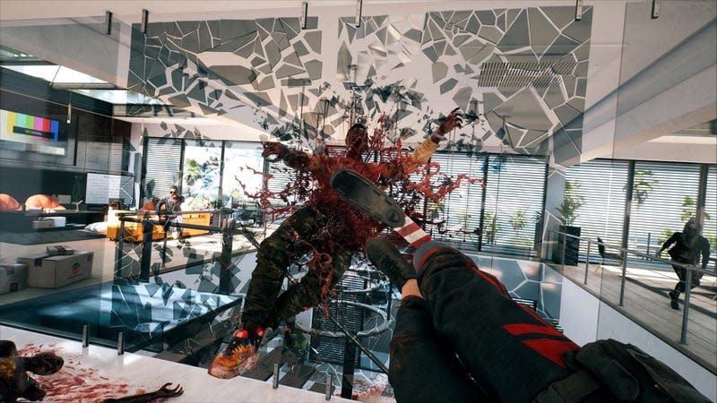 A zombie breaks through a glass wall.
