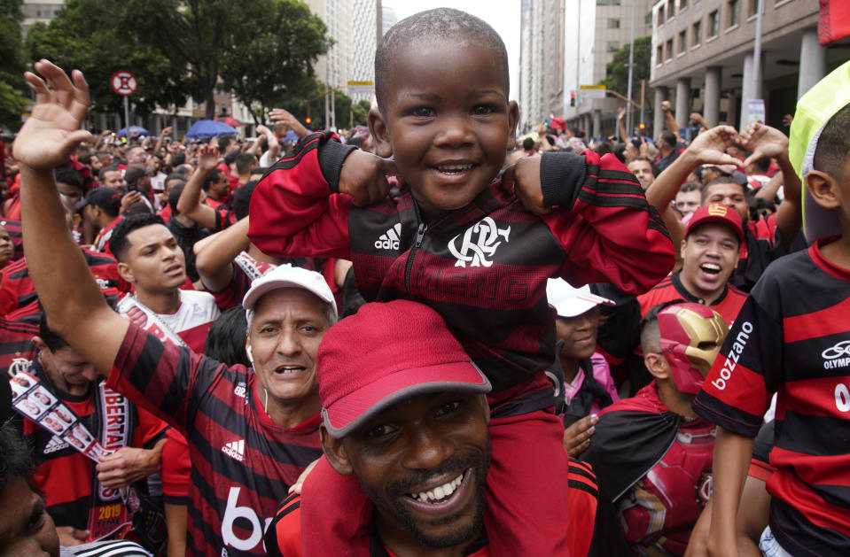 Fans of Brazil's Flamengo cheer as they wait for their arrival in Rio de Janeiro, Brazil, Sunday, Nov. 24, 2019. Flamengo overcame Argentina's River Plate 2-1 in the Copa Libertadores final match on Saturday in Lima to win its second South American title. (AP Photo/Ricardo Borges)