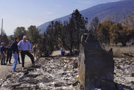 California Gov. Gavin Newsom, left, and Nevada Gov. Steve Sisolak talk as they tour destroyed home by wildfires near where the Tamarack Fire ignited earlier in July in Gardnerville, Nev., Wednesday, July 28, 2021. Nevada Gov. Steve Sisolak and California Gov. Gavin Newsom stood on ashen ground as they surveyed burned homes and a mountain range of pine trees charred by the Tamarack Fire south of Gardnerville, Nevada, near Topaz Lake. The governors, both Democrats, called on the federal government to provide more firefighting resources and stressed that climate change could make wildfires even more intense and destructive in the future. (AP Photo/Sam Metz)