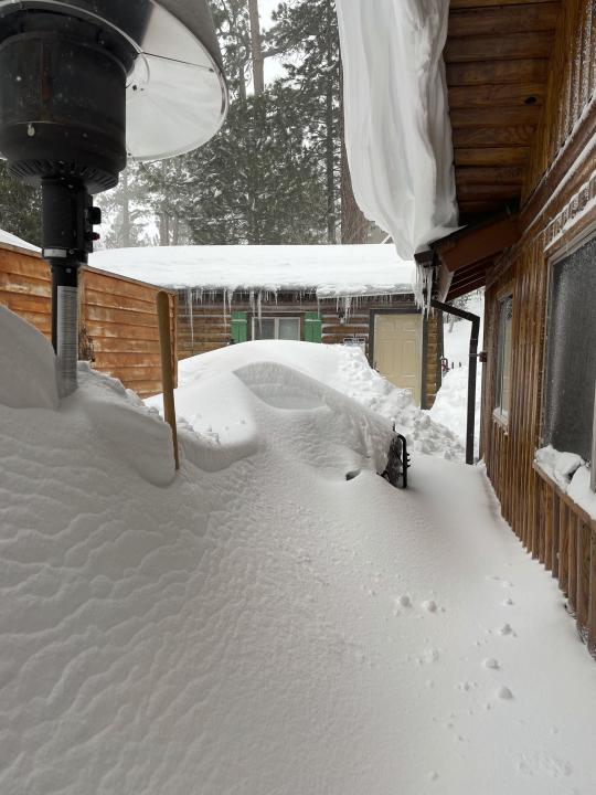 David and Kelli Góra 's home is covered after a snowstorm in Big Bear Lake, Calif., on Wednesday, March 1, 2023. (David Góra via AP)