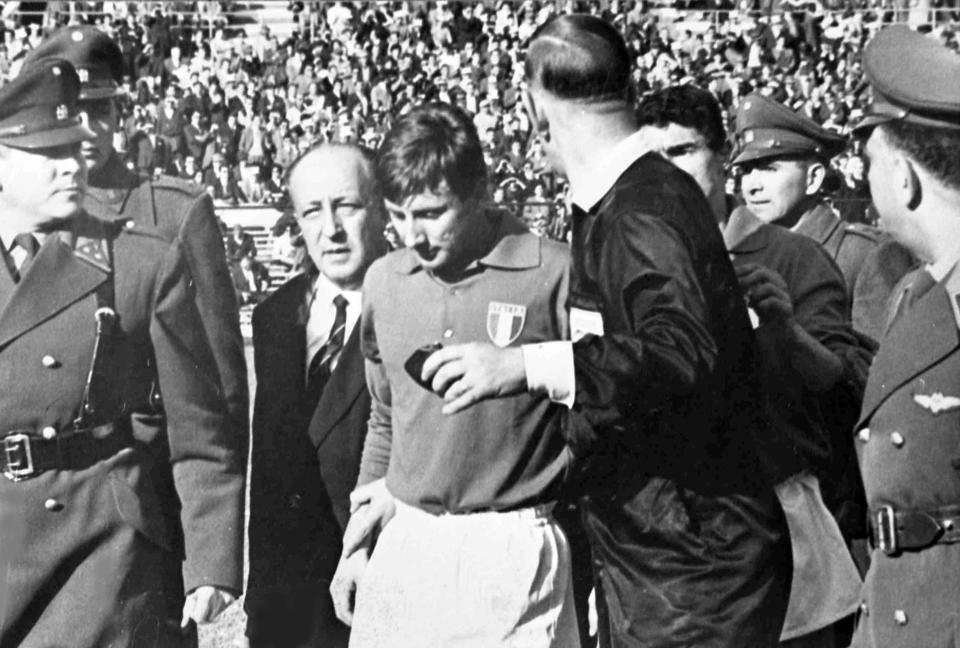 FILE - Italian forward Giorgio Ferrini, centre, is sent off by British referee Ken Aston after an incident during the first half of the World Cup soccer match against Chile in Santiago on June 2, 1962. Ferrini refused to leave the field and was removed by police officers. The match has been labelled the 'Battle of Santiago'. (AP Photo/File)