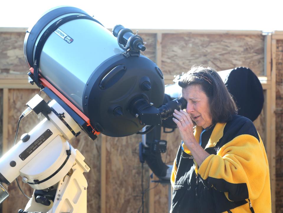 Summit County Astronomy Club member Aimee Pergalsky of Richfield looks at the sun through a telescope at the club's observation site at the Bath Nature Preserve.