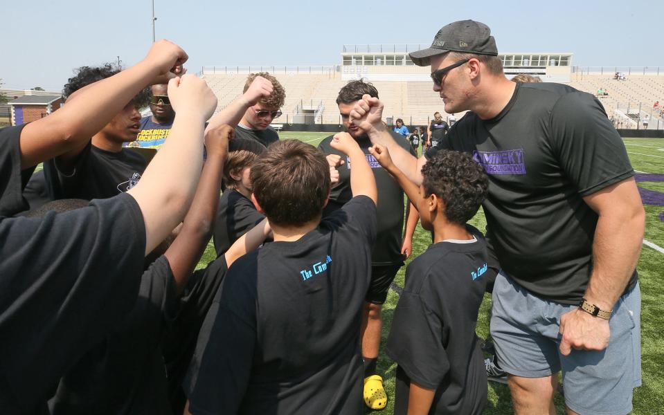 John Cominsky, a former Barberton standout and current Detroit Lion, fires up campers Saturday during the John Cominsky Youth Football Camp at Rudy Sharkey Stadium in Barberton.
