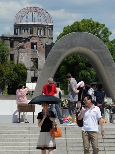 People gather to pray at the memorial for victims of the Hiroshima bombing at the Peace Memorial Park in Hiroshima, Japan