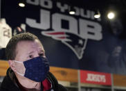 Football fan Brian Pope speaks to a reporter in the pro shop at Gillette Stadium, Monday, Jan. 25, 2021, in Foxborough, Mass. Tom Brady is going to the Super Bowl for the 10th time, and New England Patriots football fans are cheering for him -- just like before. (AP Photo/Elise Amendola)