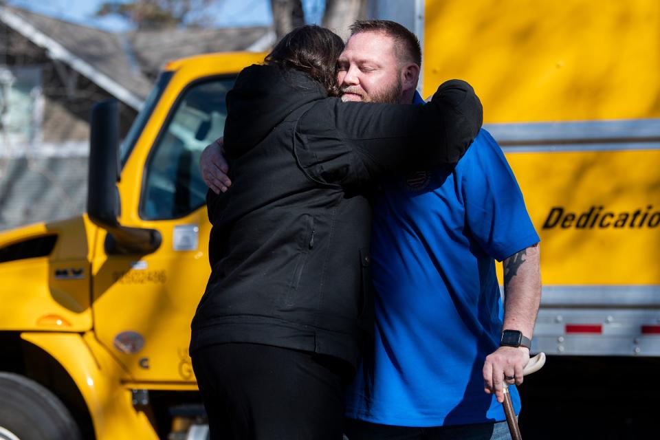 Andrea Dellinger, senior vice president of the Military Warriors Support Foundation, hugs Army veteran Michael Hulsey after he arrived at his family's new home Saturday, March 19, 2022, in Goldfield. The family was given a mortgage-free house donated by Wells Fargo to the Military Warriors Support Foundation.