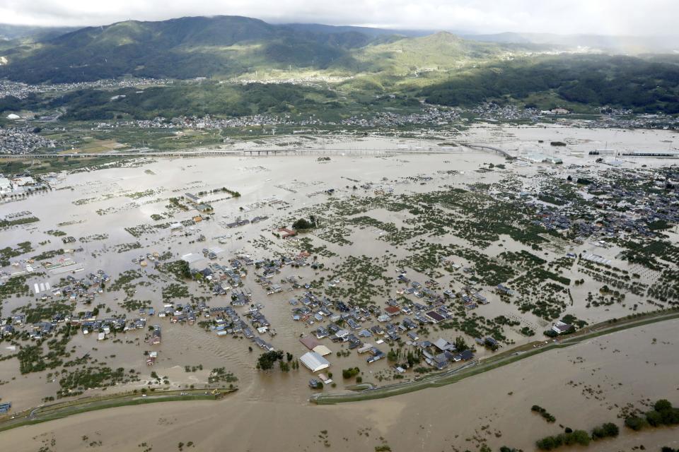 A residential area, center, is submerged in muddy waters after an embankment of the Chikuma River, bottom, broke because of Typhoon Hagibis, in Nagano, central Japan, Oct. 13, 2019. (Photo: Yohei Kanasashi/Kyodo News via AP)