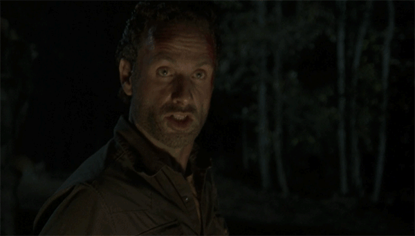 Animated GIF of Rick expressing frustration at the group while gathered around a campfire.