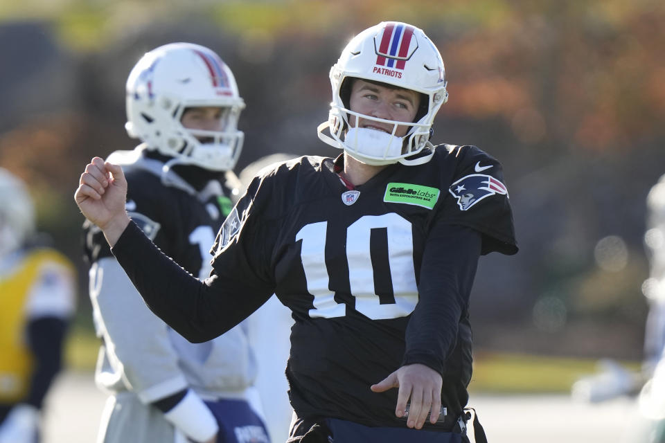 New England Patriots quarterback Mac Jones (10) stretches while warming up during an NFL football practice, Wednesday, Nov. 29, 2023, in Foxborough, Mass. (AP Photo/Steven Senne)