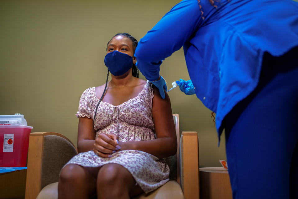 Croix Hill, 15, receives her first dose of the COVID-19 vaccine at the Ochsner Center for Primary Care and Wellness, after the Centers for Disease Control and Prevention recommended the Pfizer vaccine for use in teenagers ages 12 to 15 in New Orleans, Louisiana, U.S., May 13, 2021.   REUTERS/Kathleen Flynn