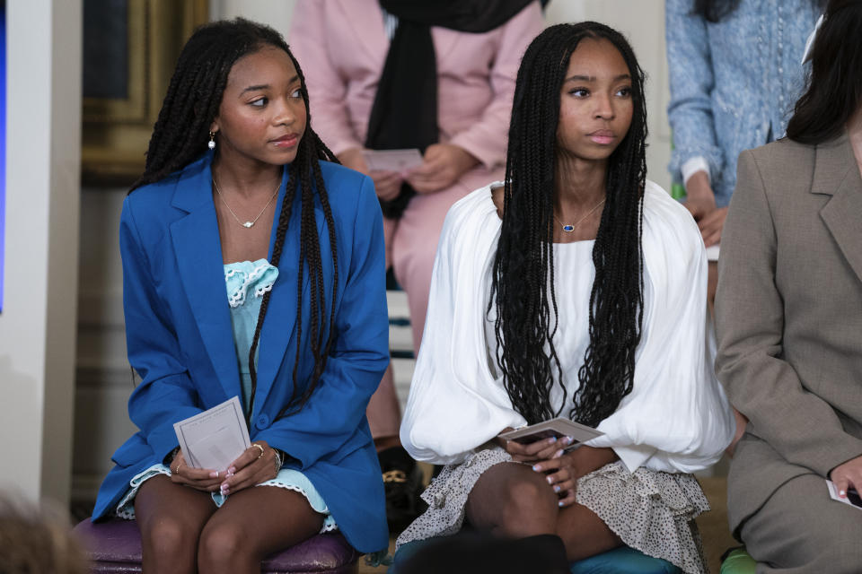 Breanna and Brooke Bennett, of Montgomery, Ala., listen as first lady Jill Biden speaks during a "Girls Leading Change" event to honor International Day of the Girl, in the East Room of the White House, Wednesday, Oct. 11, 2023, in Washington. (AP Photo/Evan Vucci)