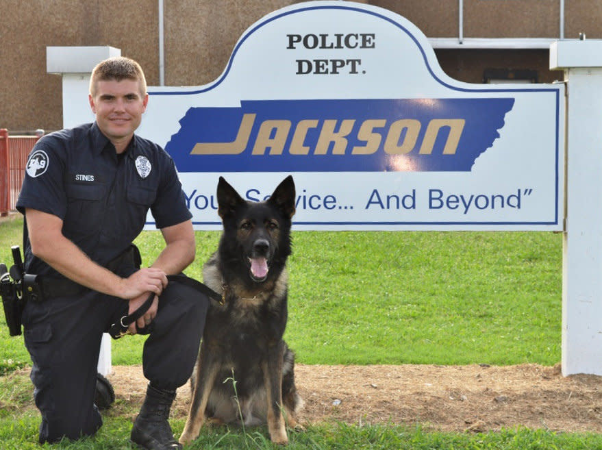 This undated photo provided by the Jackson, Tenn. Police Department on Wednesday, July 23, 2014 shows Farro, a police dog, and his partner, K9 Officer Jeremy Stines. On Wednesday, police said that the 9-year-old German shepherd has died. He became sick during Memorial Day weekend, and was found to have cancer. The department's first dual-purpose dog worked to detect drugs and apprehend crime suspects. (AP Photo/Jackson Police Department)