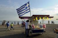 A Greek national flag is placed at a stall selling candy floss at the northern city of Thessaloniki, Greece July 1, 2015. REUTERS/Alexandros Avramidis