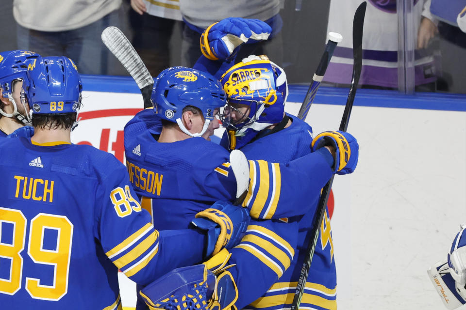 Buffalo Sabres left wing Victor Olofsson (71) and goaltender Craig Anderson (41) celebrate a 4-3 victory over the Chicago Blackhawks following the overtime period of an NHL hockey game, Saturday, Oct. 29, 2022, in Buffalo, N.Y. (AP Photo/Jeffrey T. Barnes)