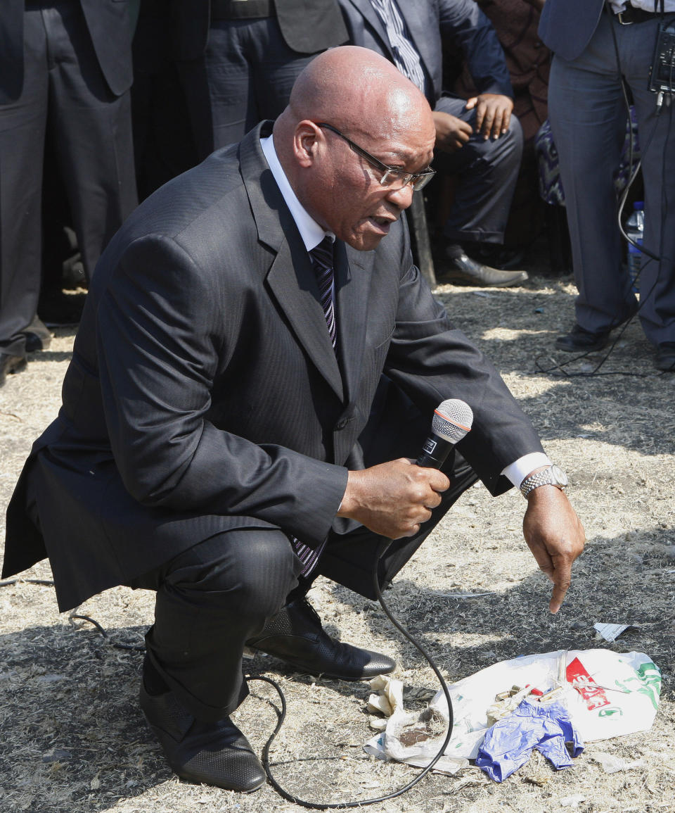 CORRECTS DATE South Africa's President Jacob Zuma interacts with striking mine workers at the Lonmin mine near Rustenburg, South Africa, Wednesday, Aug. 22, 2012. Demands for higher wages spread to at least two other platinum mines in South Africa and raise fears instability could spread to more of the country's mines that provide 75 percent of the world's supply of the precious metal. South Africa's miningweb.co.za Web site calls it "a possibly ominous development." A 12-day strike at the Lonmin PLC mine resulted in police killing 34 striking miners and wounding another 78 last week. (AP Photo/Themba Hadebe)