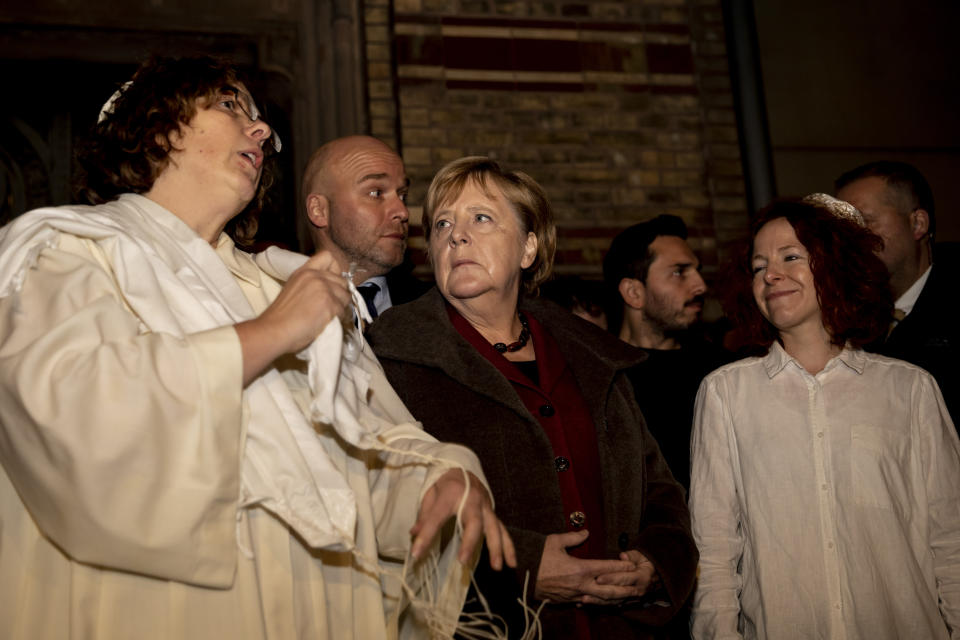 German Chancellor Angela Merkel, Center, attends a solidarity event at the 'Neue Synagoge' (new synagogue) in Berlin, Germany, Wednesday, Oct. 9, 2019. A heavily armed assailant tried to force his way into a synagogue in the German city of Halle on Wednesday on Yom Kippur, Judaism's holiest day, and two people were killed as he fired shots outside the building and into a kebab shop, authorities and witnesses said. (Christoph Soeder/dpa via AP)