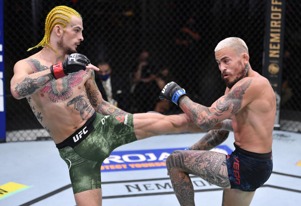 LAS VEGAS, NEVADA - AUGUST 15: (L-R) Sean O'Malley kicks Marlon Vera of Ecuador in their bantamweight bout during the UFC 252 event at UFC APEX on August 15, 2020 in Las Vegas, Nevada. (Photo by Jeff Bottari/Zuffa LLC)