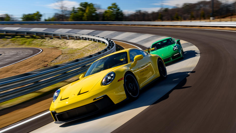 A Porsche 911 GT3 and 911 Turbo play cat and mouse around the Porsche Experience Center Atlanta's Carousel feature on the new 1.3-mile handling circuit.