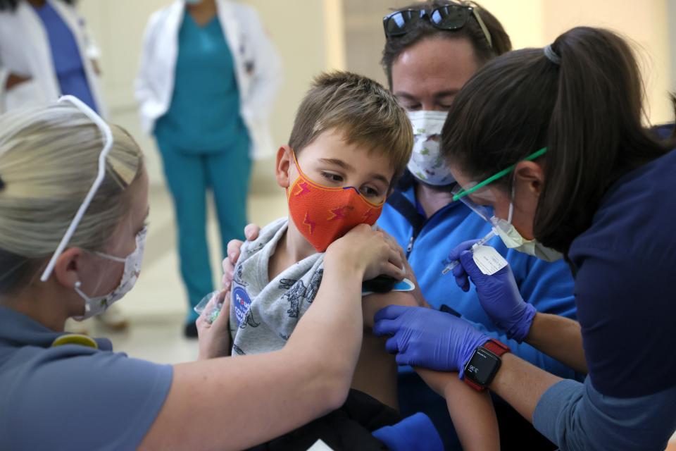 Connor, 5, sits on his dad Eric Sefton's lap while receiving his Pfizer COVID-19 vaccine, now approved for 5-11 year olds, as children of staff members at Le Bonheur are some of the first to receive the vaccine on Thursday, Nov. 4, 2021.