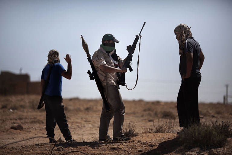 Libyan rebels gather at the front line on the eastern ridge of the Nafusah Mountains in Western Libya, on the outskirt of Gualish. Forces loyal to Moamer Kadhafi launched a counter-attack on Sunday against rebel advance positions southwest of Tripoli, an AFP correspondent said, as rebels cut off an oil pipeline used to supply the Libyan strongman's forces