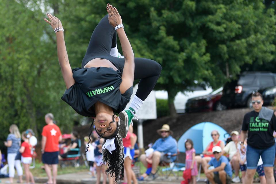 A member of Inspirations Dance & Gymnastics Studio performs in the Farragut Independence Day Parade along Kingston Pike in Farragut, Tenn. on Monday, July 4, 2022.