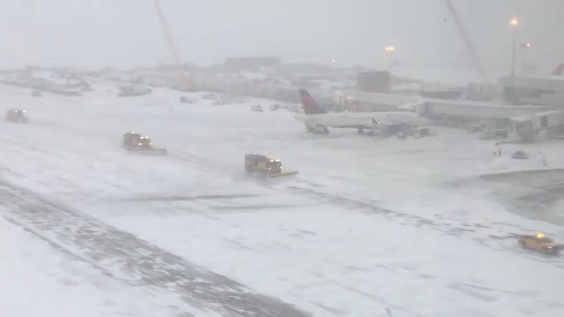 Snow is cleared off runways at Denver International Airport after a heavy snowfall hit Colorado in this November 26, 2019 picture obtained from social media