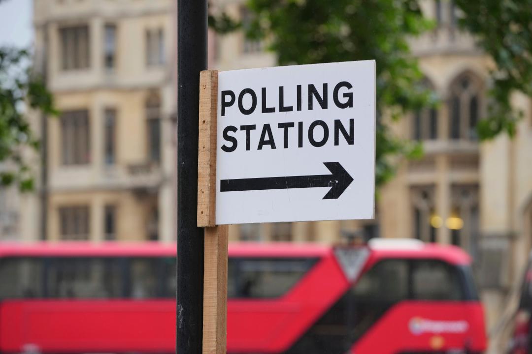 A polling station sign points to where local residents can cast their votes ahead of the general election, in London, Wednesday, July 3, 2024. (AP Photo/Kin Cheung)