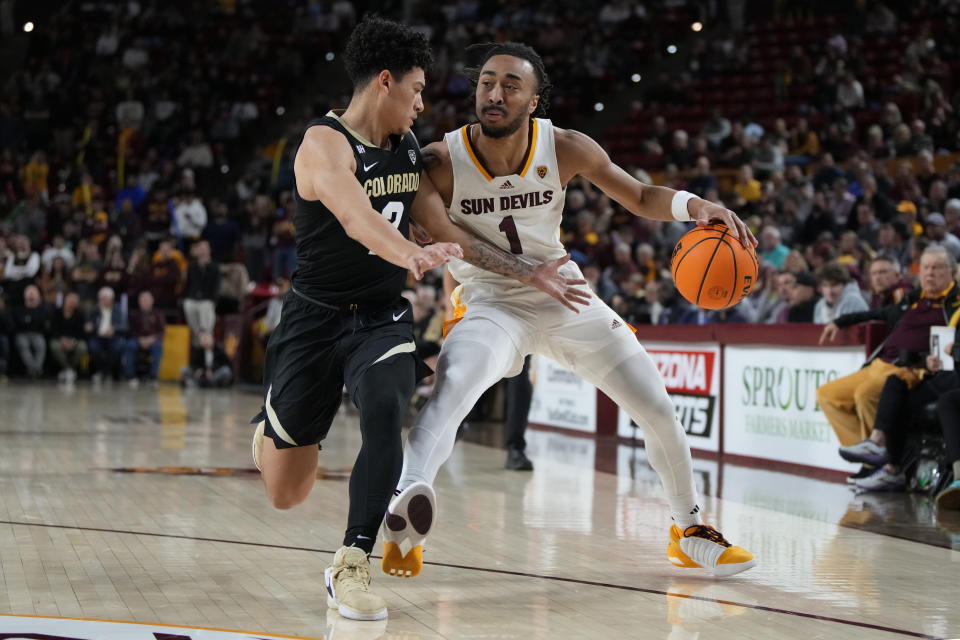 Arizona State guard Frankie Collins (1) shields the ball from Colorado guard KJ Simpson, left, during the second half of an NCAA college basketball game, Saturday, Jan. 6, 2024, in Tempe, Ariz. (AP Photo/Rick Scuteri)