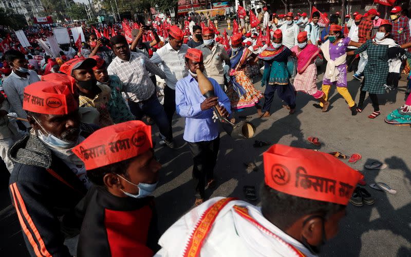 Farmers perform a folk dance during a protest against new farm laws in Mumbai