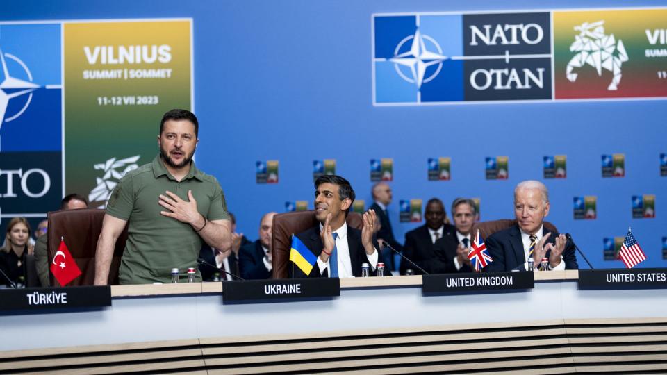 Ukrainian President Volodymyr Zelenskyy, left, receives applause from NATO members during the alliance's summit in Vilnius, Lithuania, on July 12, 2023. (Doug Mills/AFP via Getty Images)