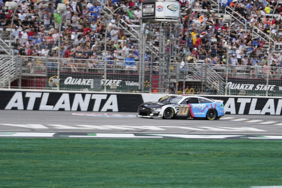 Drivers Aric Almirola (10) leads from the start during a NASCAR Cup Series auto race at Atlanta Motor Speedway on Sunday, July 9, 2023, in Hampton, Ga. (AP Photo/Brynn Anderson)