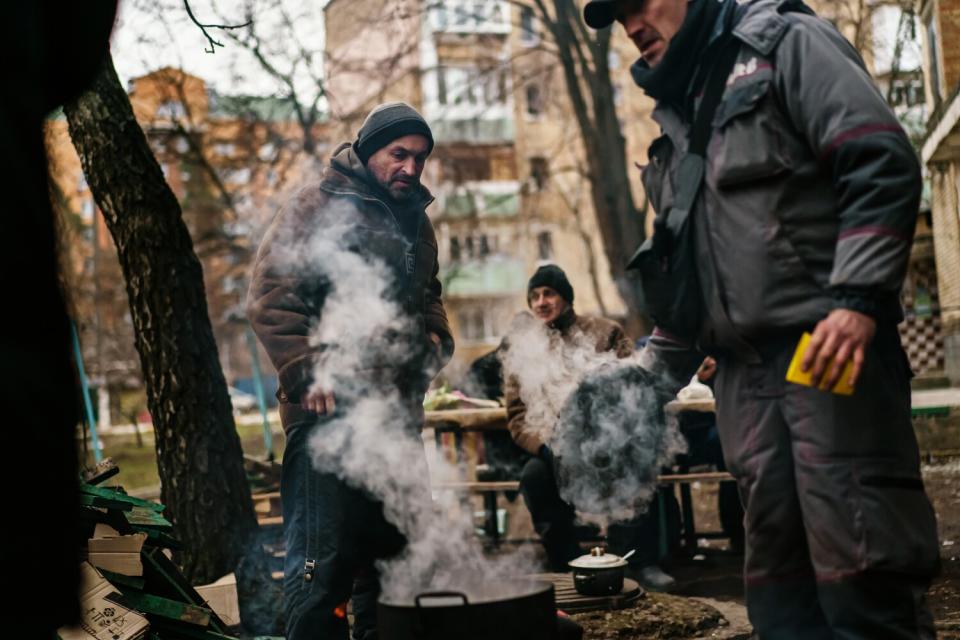 Irpin residents on the edge of town, close to the front line, gather outside and make a communal meal Saturday.