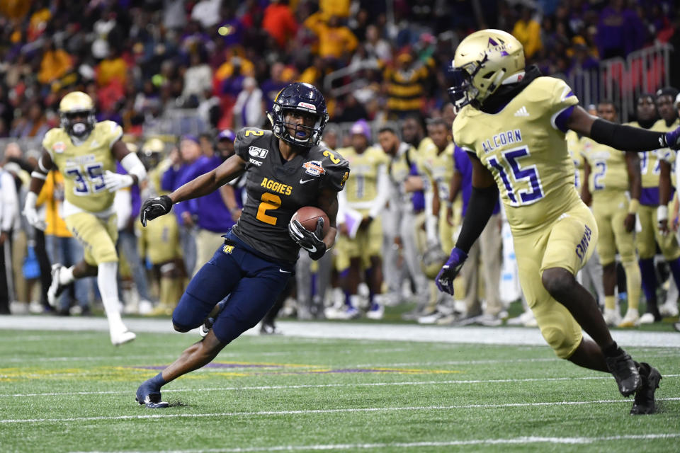 North Carolina A&T wide receiver Korey Banks (2) cuts back on Alcorn State defensive back Keyron Kinsler Jr. (15) during a long run in the second half of the Celebration Bowl NCAA college football game, Saturday, Dec. 21, 2019, in Atlanta. North Carolina A&T won 64-44. (John Amis/Atlanta Journal-Constitution via AP)