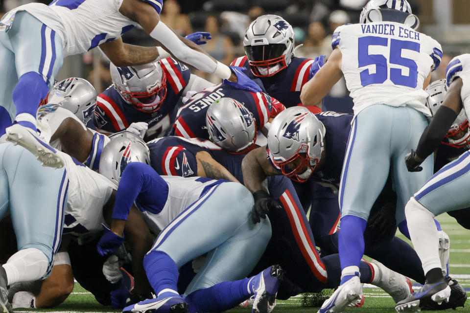 New England Patriots quarterback Mac Jones, center, is unable to get a first down on a fourth and short attempt as Dallas Cowboys linebacker Leighton Vander Esch (55) and the defense combine to make the stop in the first half of an NFL football game in Arlington, Texas, Sunday, Oct. 1, 2023. (AP Photo/Michael Ainsworth)