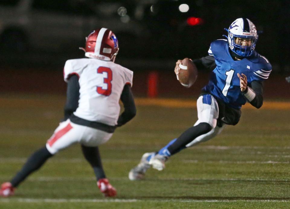 Batavia quarterback Javin Mcfollins (1), right, cuts back upfield away from Monroe's Noah Mather (3), right, during their Section V football Class B championship game Saturday, Nov. 12, 2022 at SUNY Brockport.