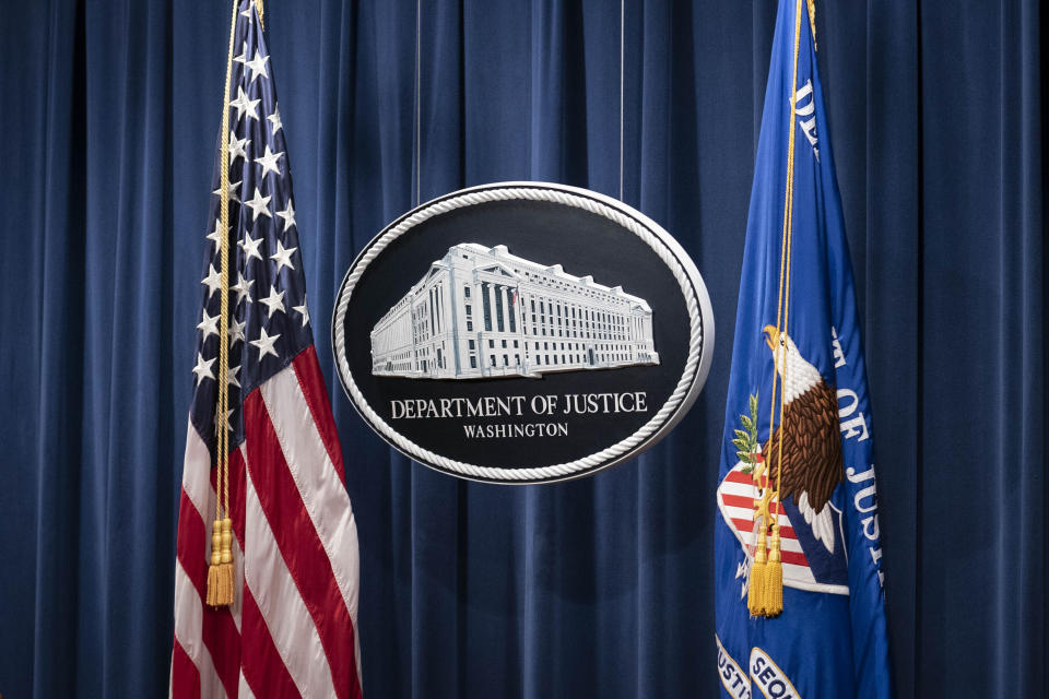 FILE - This Jan. 12, 2021, file photo shows a sign for the Department of Justice ahead of a news conference in Washington. The elite Russian hackers who gained access to computer systems of federal agencies last year didn’t bother trying to break one-by-one into the networks of each department. Instead, they got inside by sneaking malicious code into a software update pushed out to thousands of government agencies and private companies. (Sarah Silbiger/Pool via AP, File)